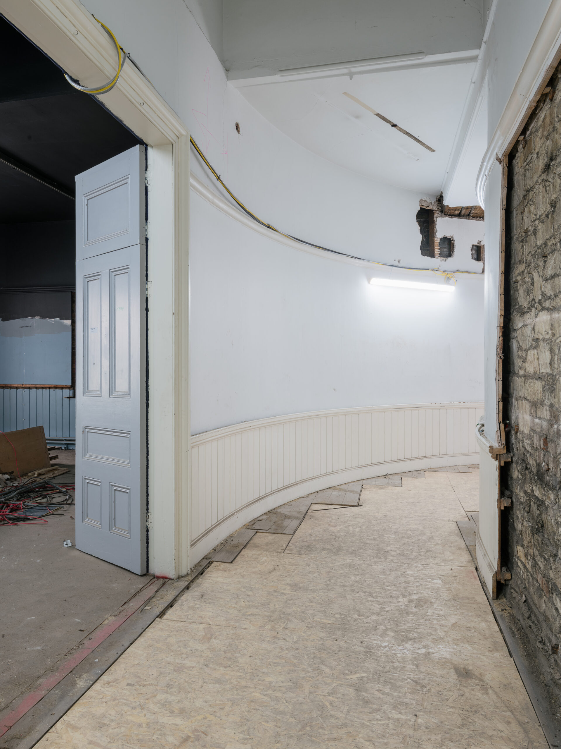 An interior curved corridor.
