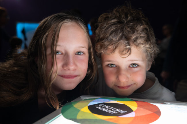 Two children with a Culture Night Logo