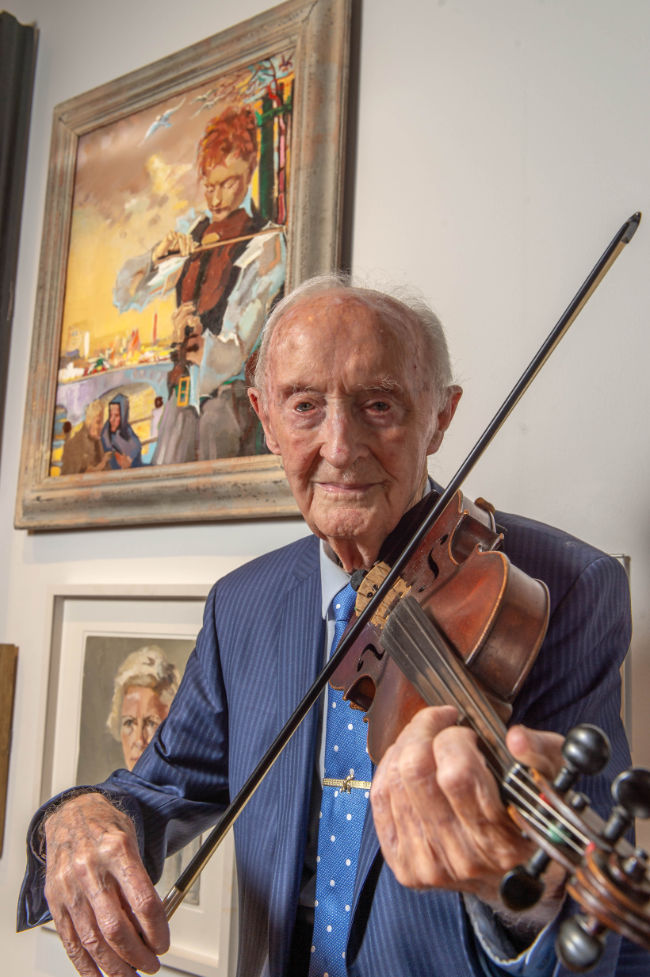 A old man playing the fiddle.